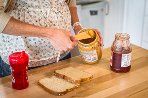 spreading peanut butter with wood butter knife Earlywood