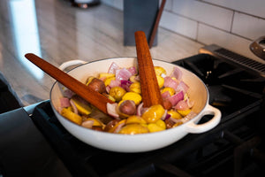 two thin flat wooden saute tools on viking range - Earlywood