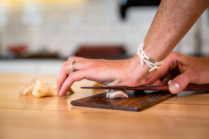 using wood kitche scraper as garlic crusher - Earlywood
