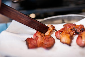 using wooden cooking tongs to turn bacon - earlywood